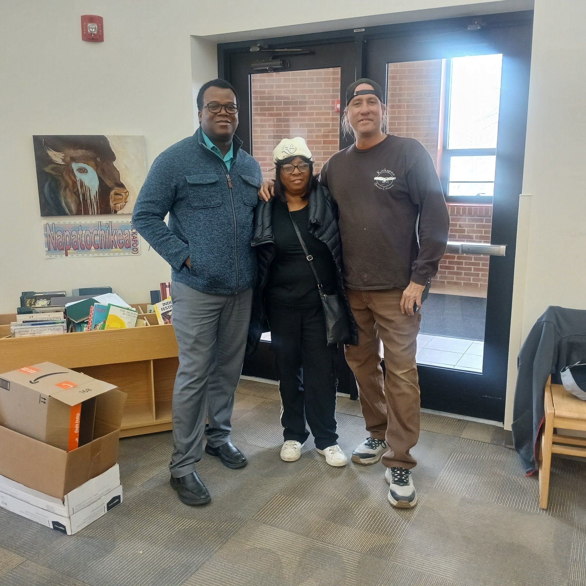 Three people posing together at the Napatochikea library
