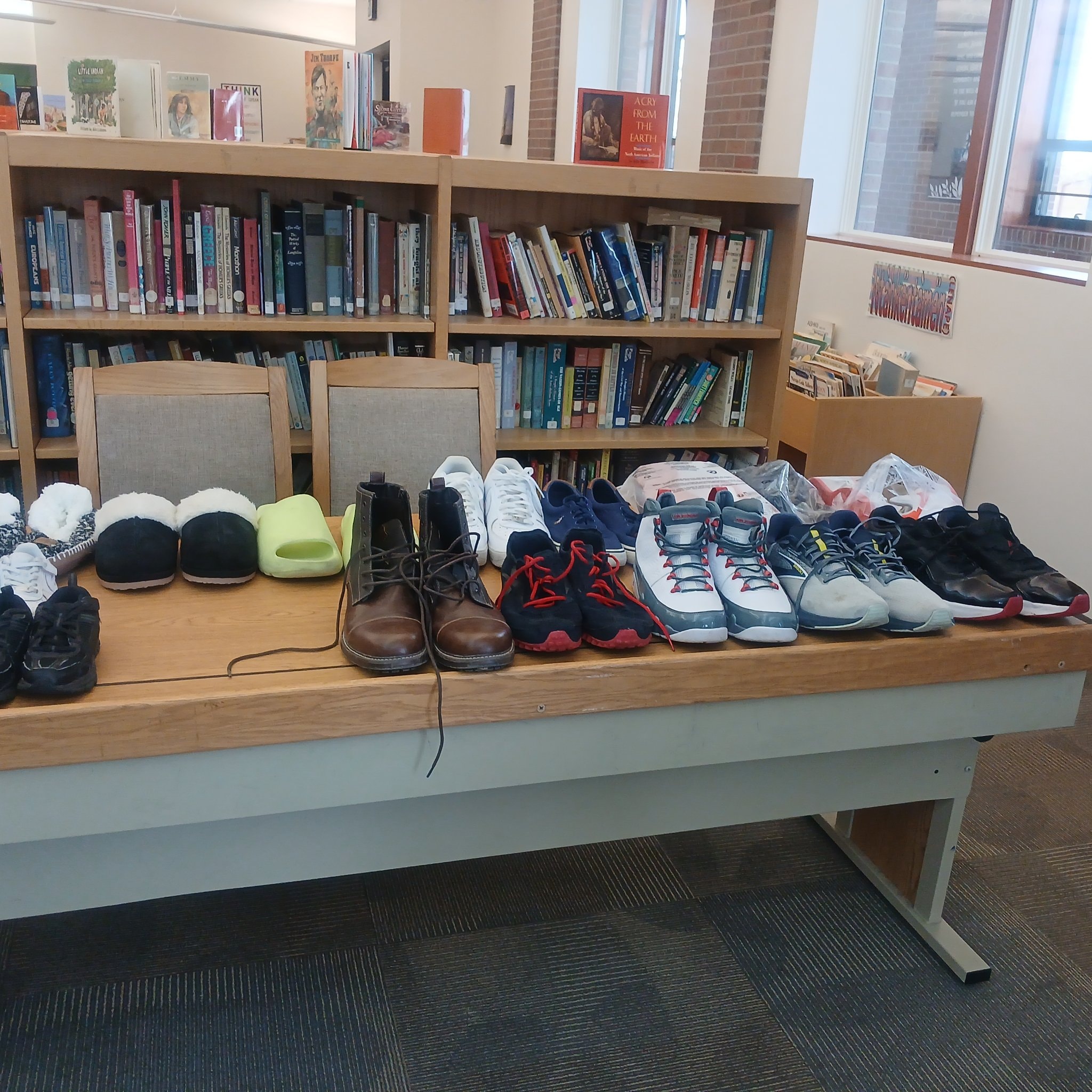 Donated shoes and clothing on display table