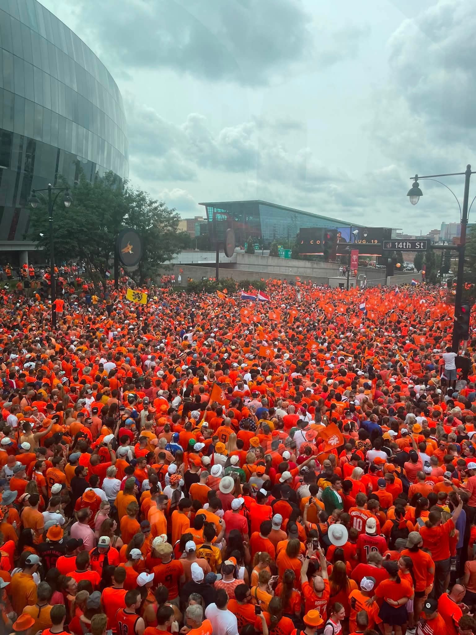 Huge orange-clad soccer crowd at 14th St, Soccer in the City Kansas City