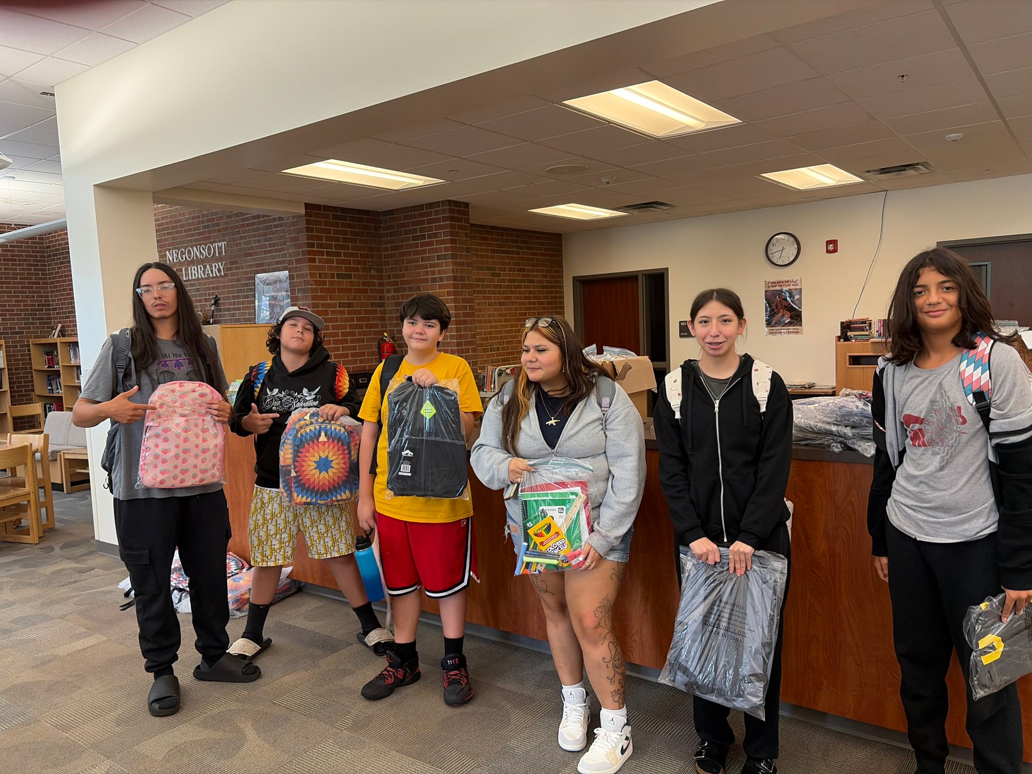 Teens with backpacks at Negonsott Library