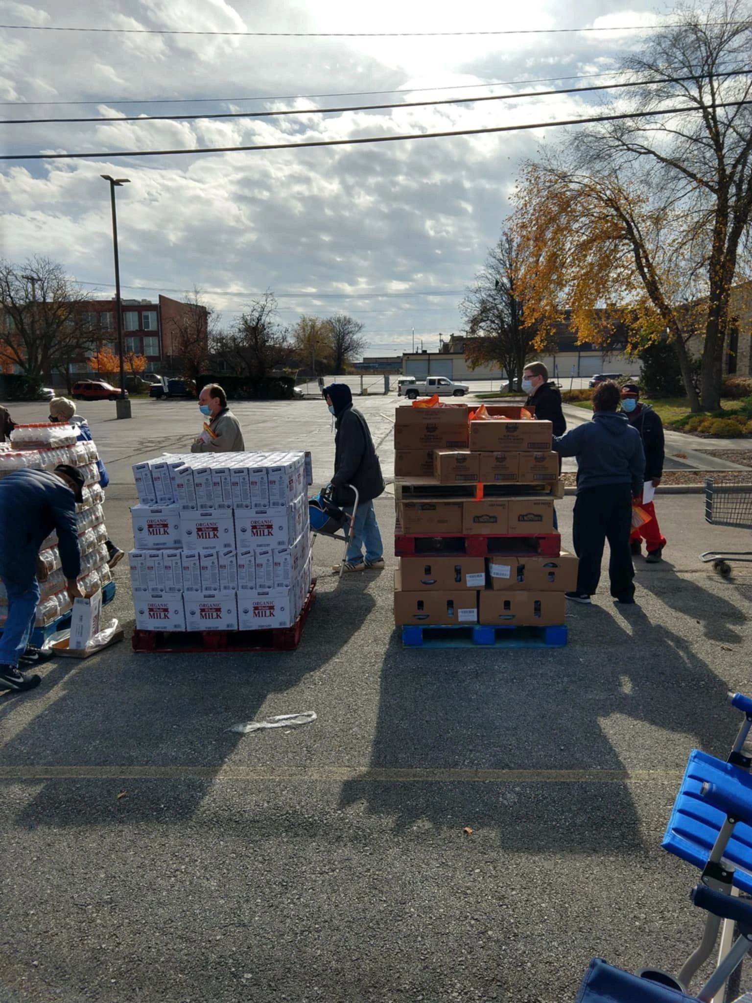Community food distribution event with milk and packaged goods