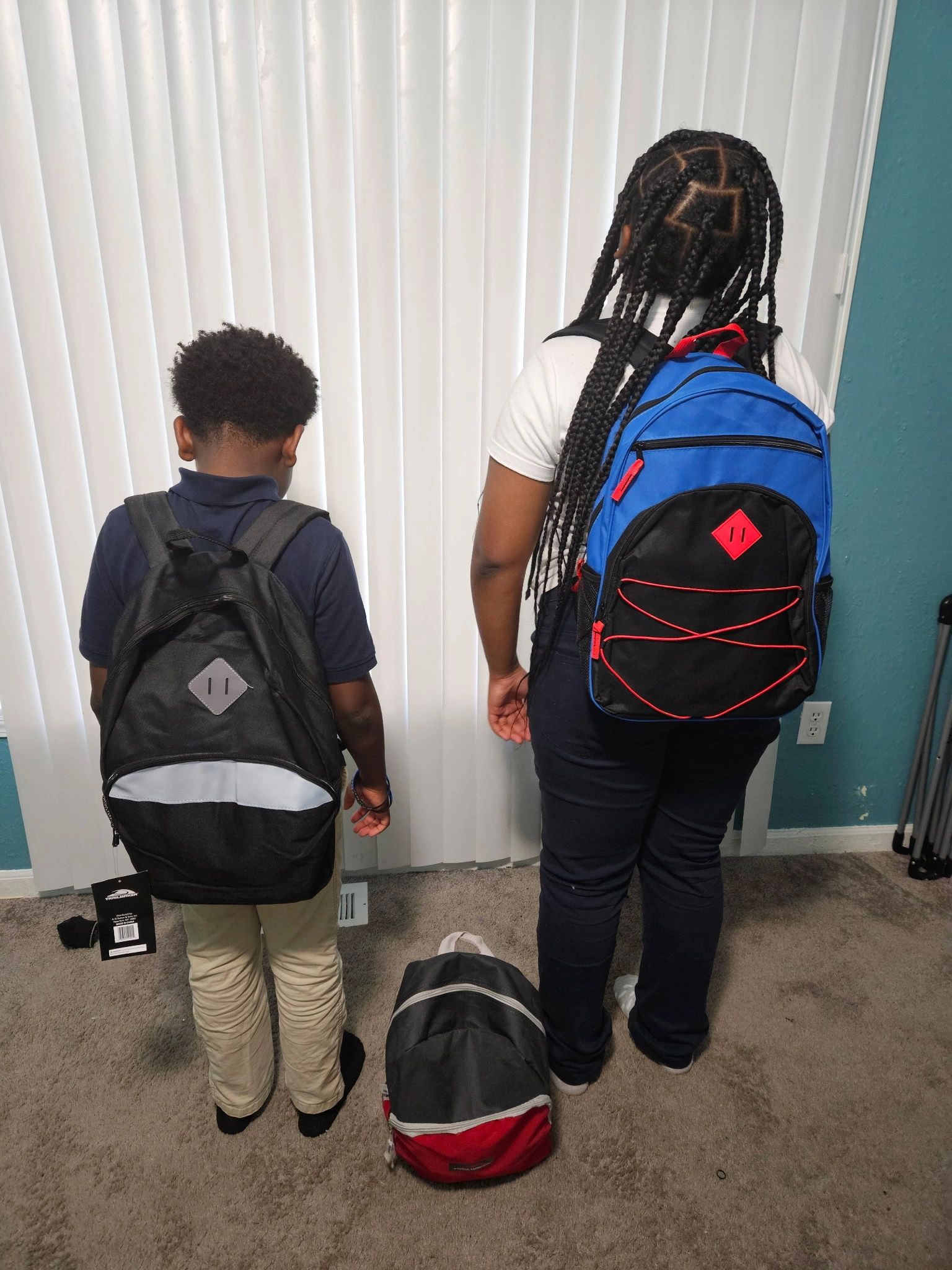 Two children with backpacks ready for school